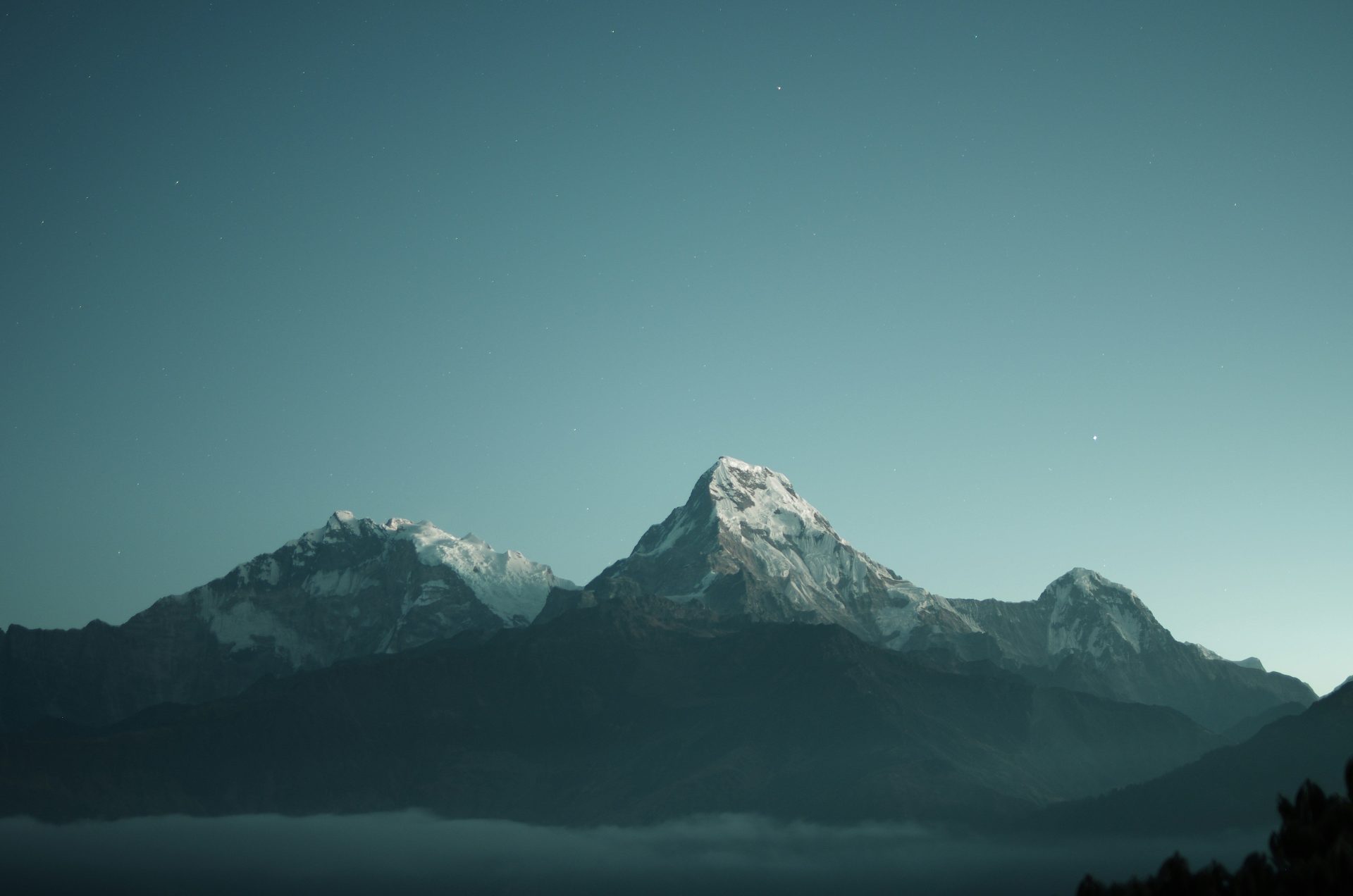 Snow-capped peaks of the Annapurna range above a layer of clouds in Nepal